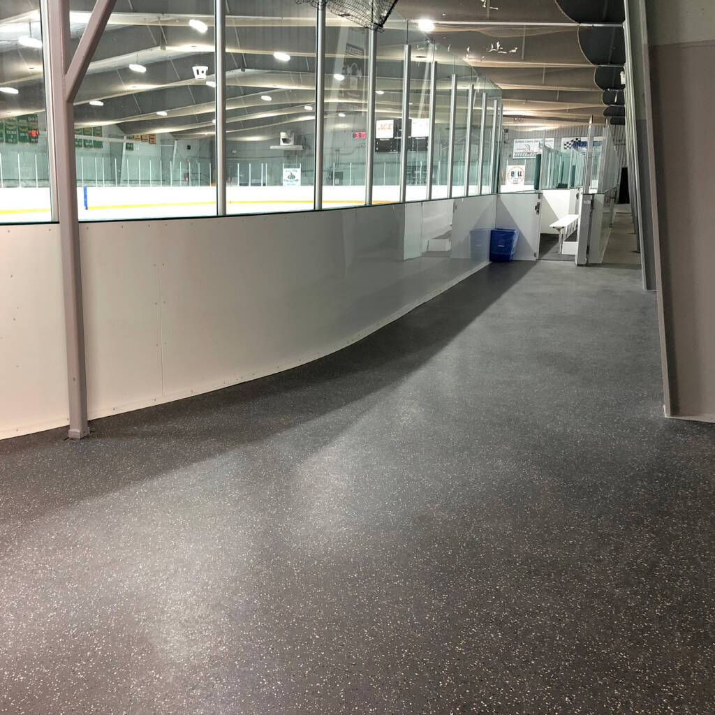 Rubber flooring around perimeter in ice arena